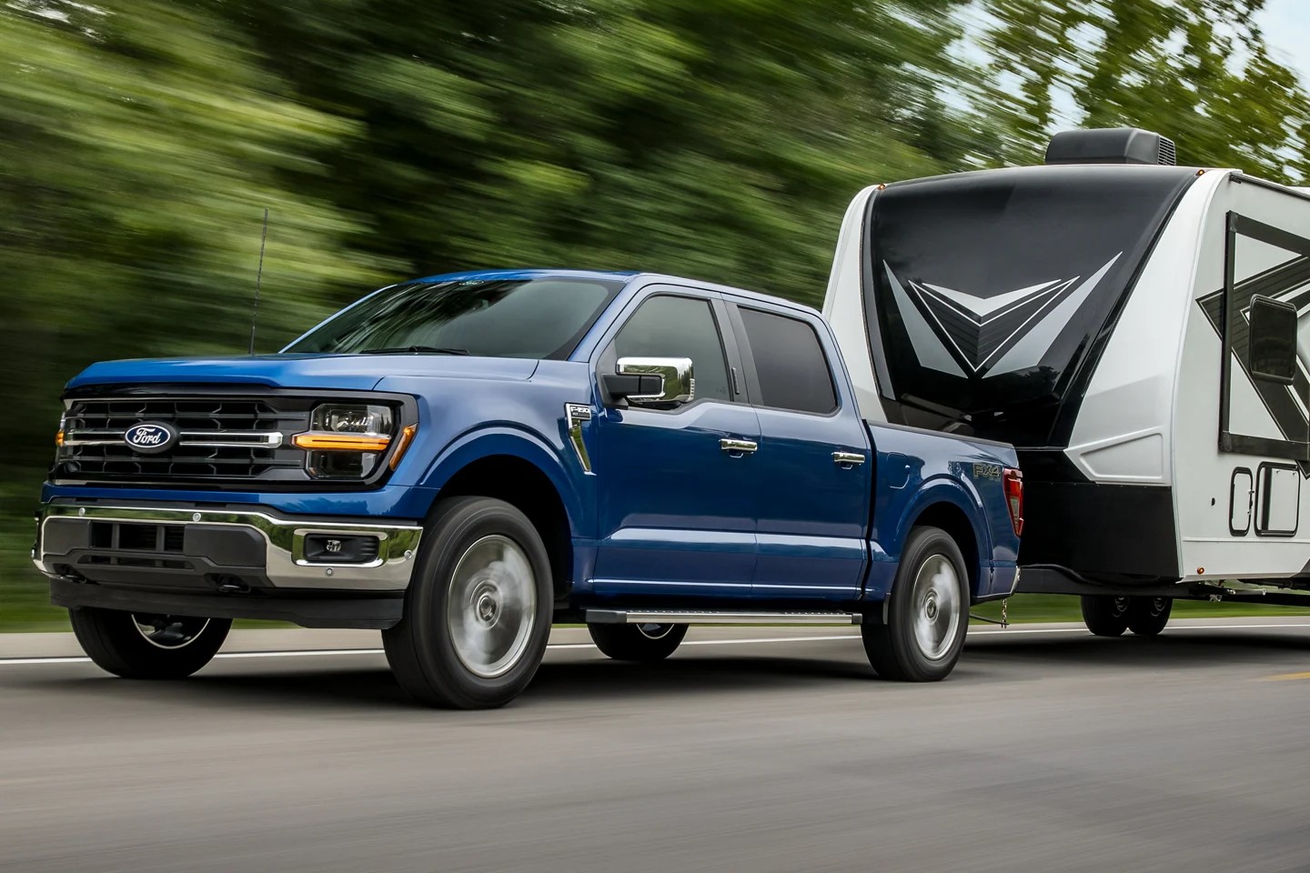 Blue Ford F-150 pulling a trailer