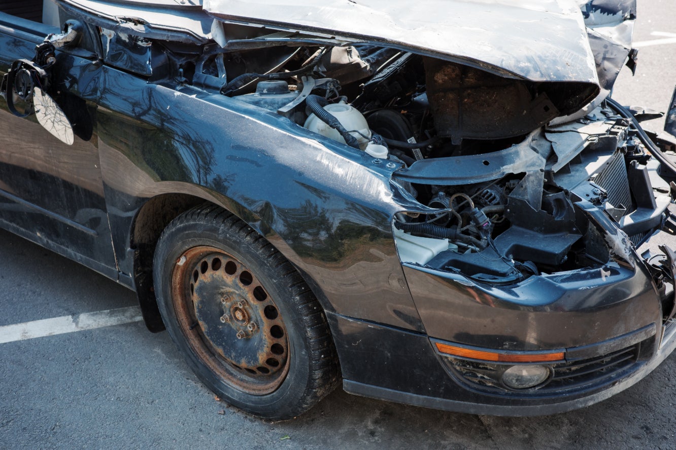 A demolished black car.