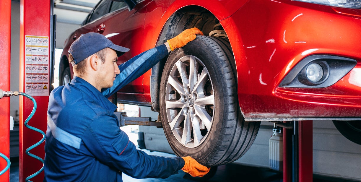 Technician performing a check on a tire